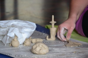 Hand moulding clay pieces