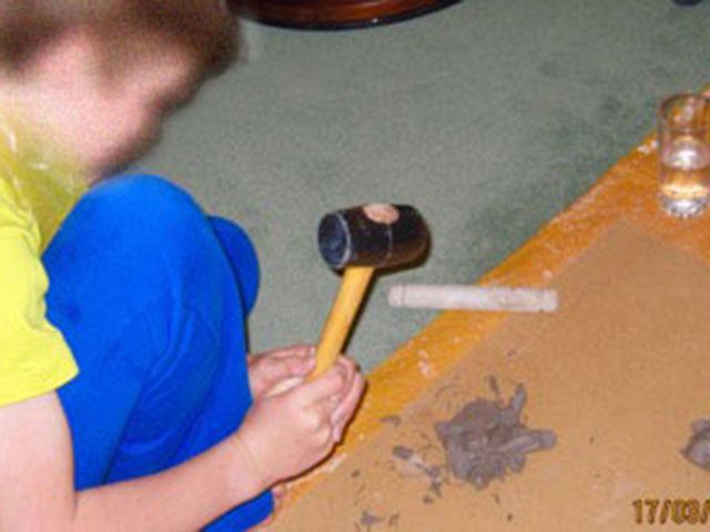 Boy playing with plastercine