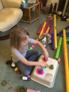 Young girl playing with clay